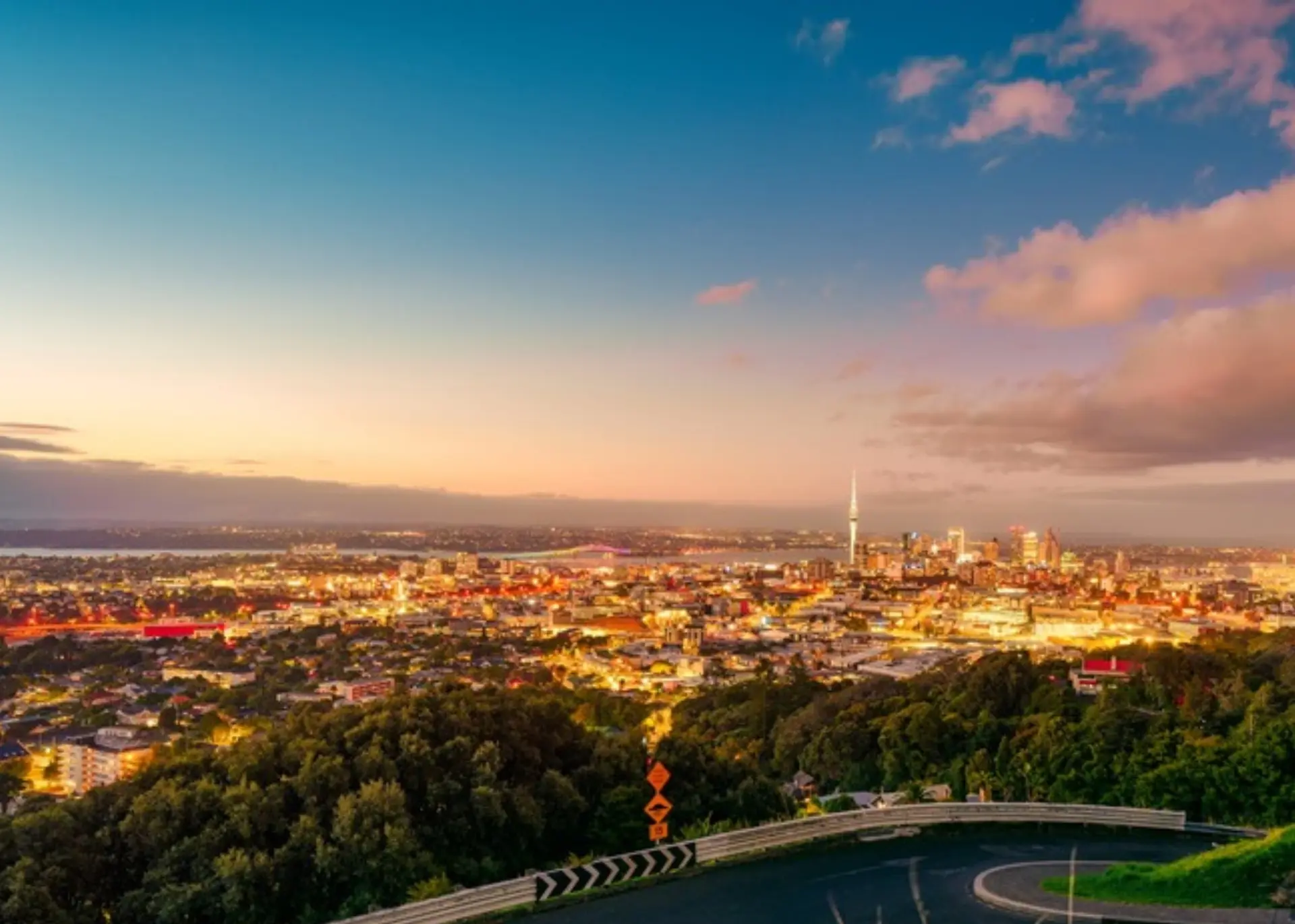 The Sky Tower and the Auckland city lights at dusk, for Sylvie di Giusto, international keynote speaker in Auckland
