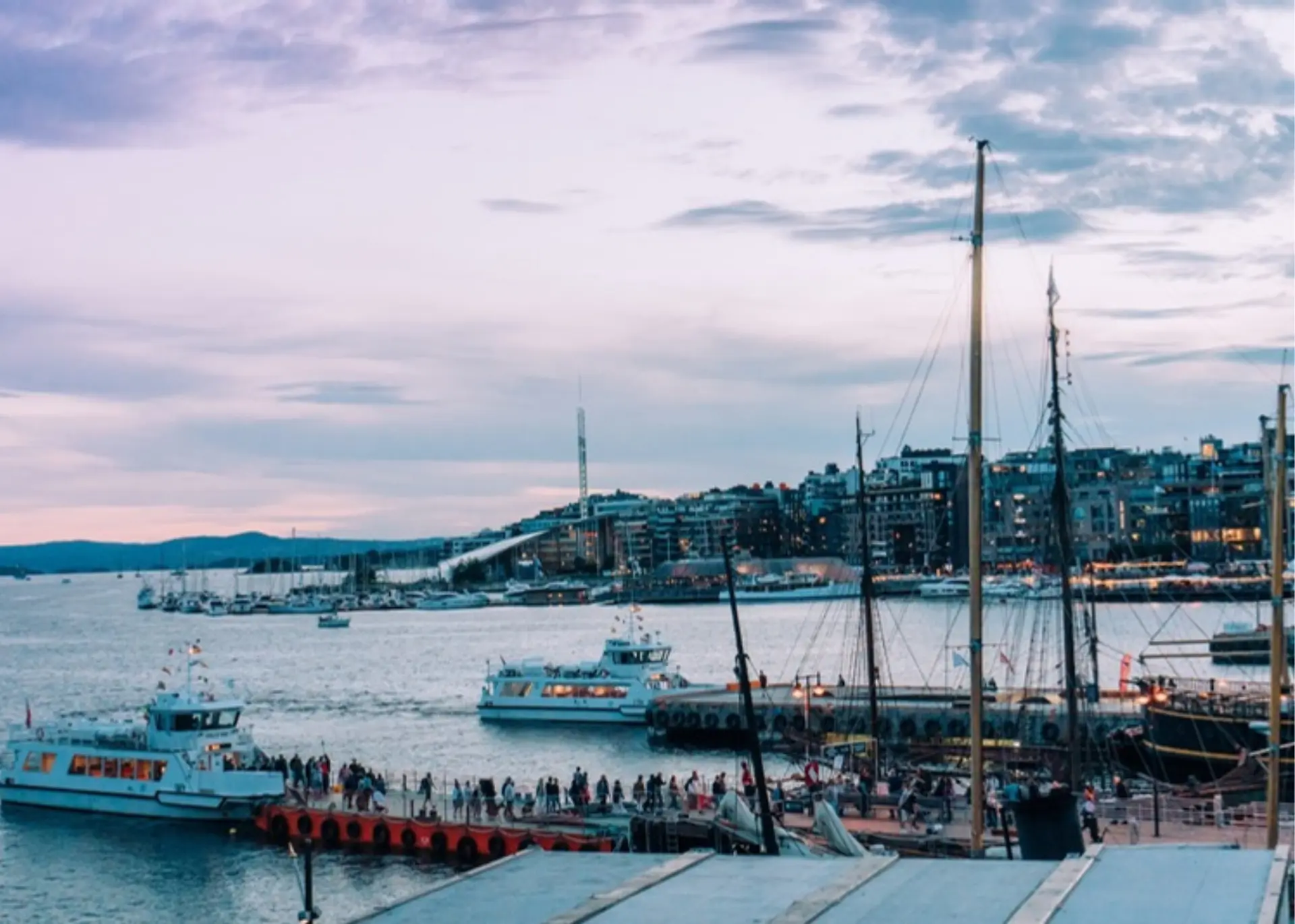 Boats and the Aker Brygge waterfront on the Oslo harbour at dusk, for Sylvie di Giusto, international keynote speaker in Oslo
