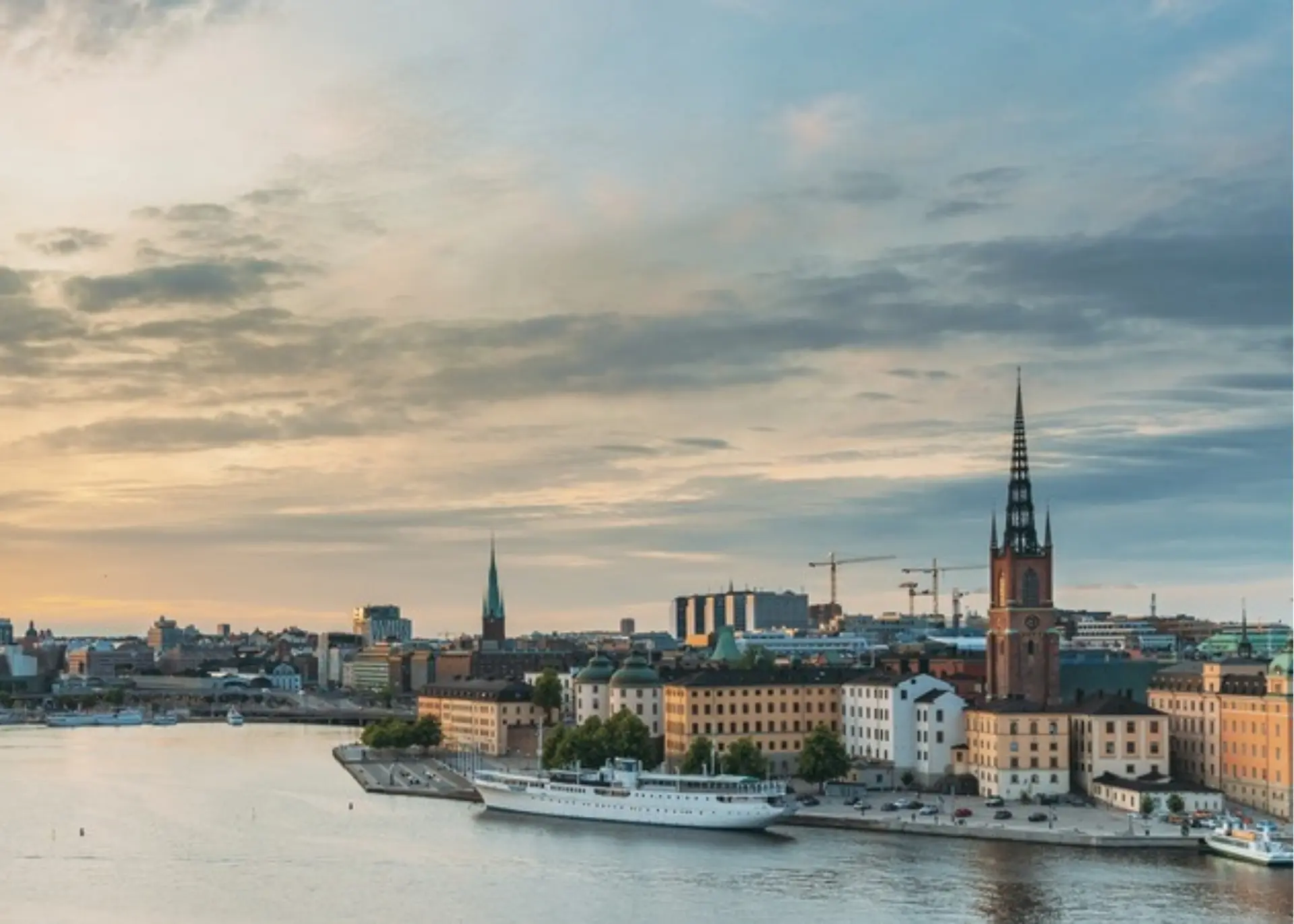 Riddarholmen Church and the Stockholm waterfront at sunset, for Sylvie di Giusto, international keynote speaker in Stockholm