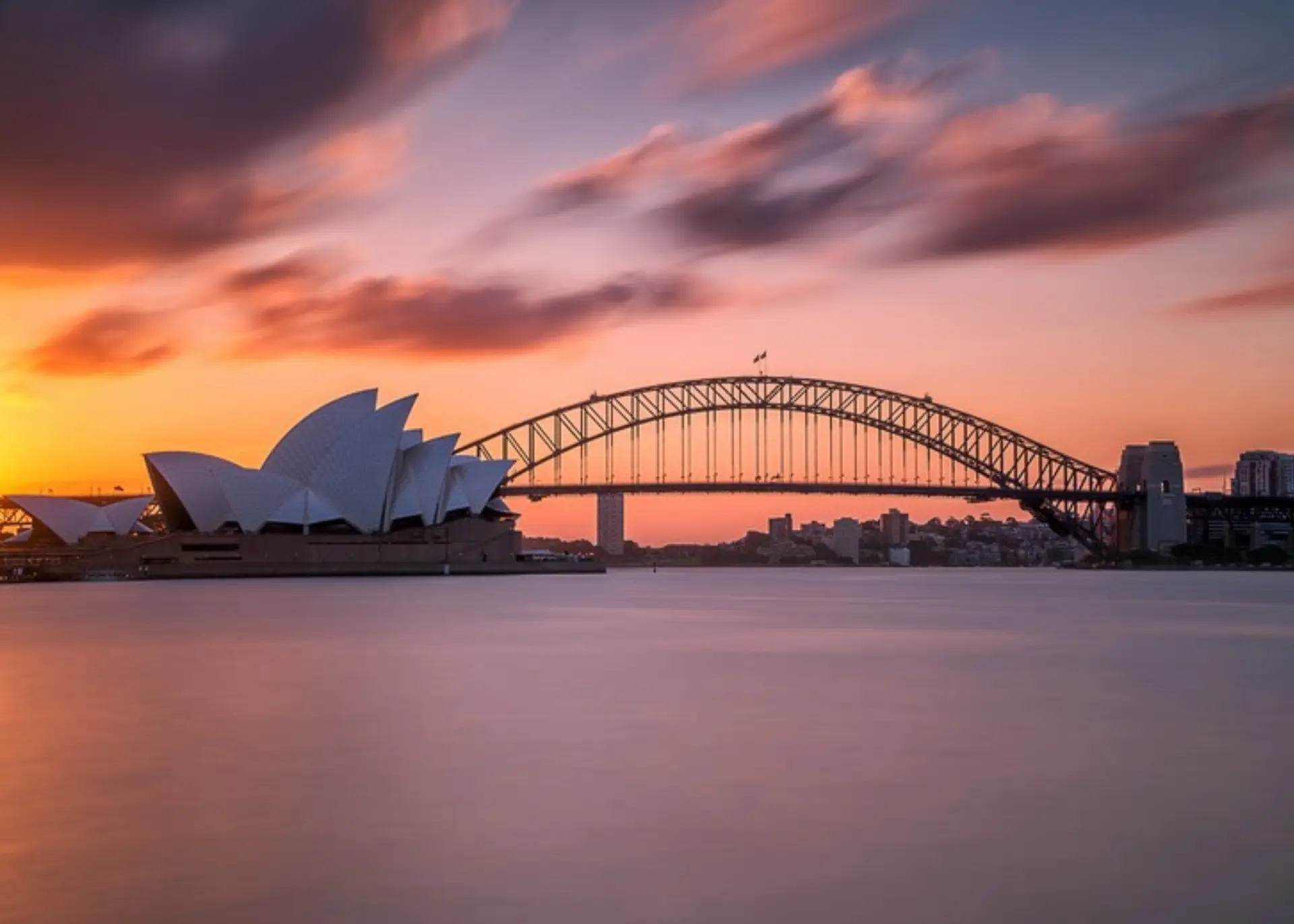 The Sydney Opera House and Harbour Bridge on Sydney Harbour at sunset, for Sylvie di Giusto, international keynote speaker in Sydney